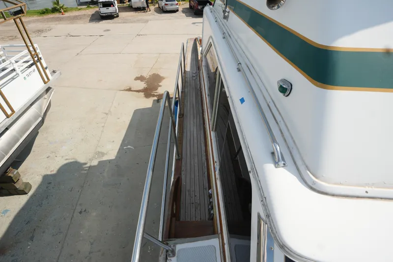 Slide: The Image of 1960 Matthews 42 Stock Cruiser docked, showing side deck and railing details. - 8