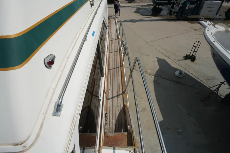 Slide: The Image of 1960 Matthews 42 Stock Cruiser docked, showcasing side deck and railing details. - 9