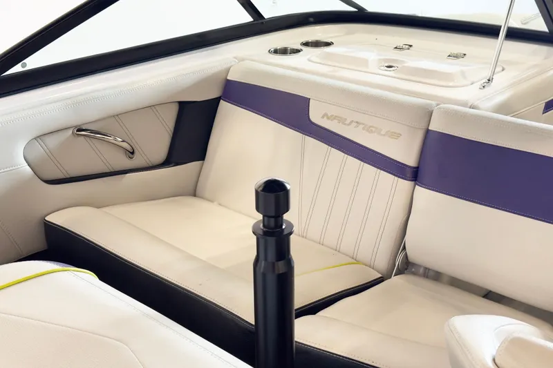 Slide: The Image of 2014 Nautique Ski Nautique 200 interior with white and purple seating, sleek design. - 10