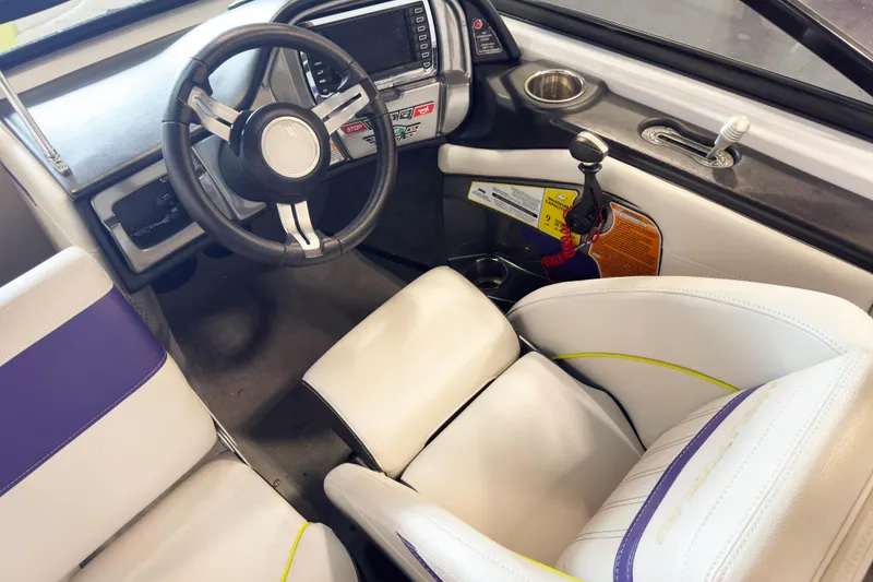 Slide: The Image of Interior of 2014 Nautique Ski Nautique 200 Closed Bow boat with steering wheel and seating. - 13