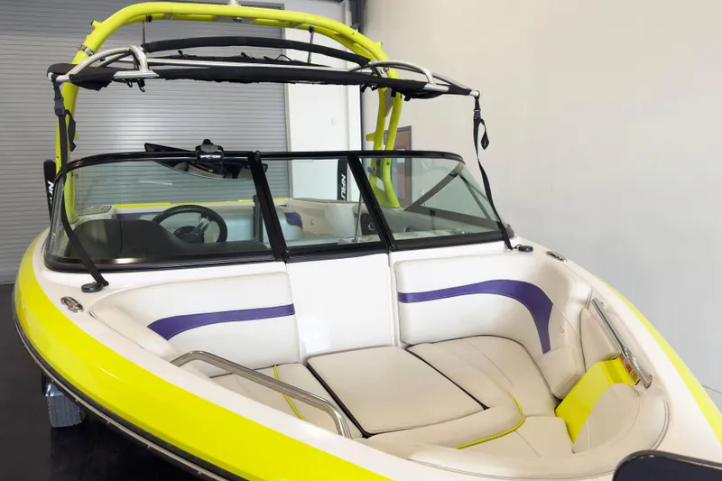 Slide: The Image of 2014 Nautique Ski Nautique 200 Closed Bow boat with vibrant yellow and purple interior. - 4