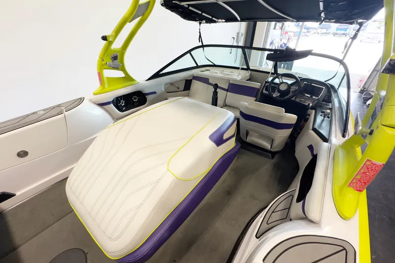 Slide: The Image of 2014 Nautique Ski Nautique 200 Closed Bow interior with vibrant yellow and purple accents. - 8