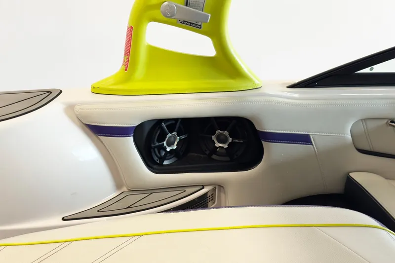 Slide: The Image of 2014 Nautique Ski Nautique 200 interior with speaker and vibrant yellow accents. - 11