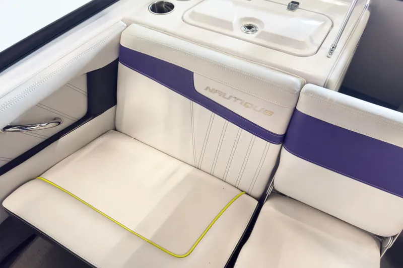 Slide: The Image of 2014 Nautique Ski Nautique 200 Closed Bow interior with white and purple seating. - 14