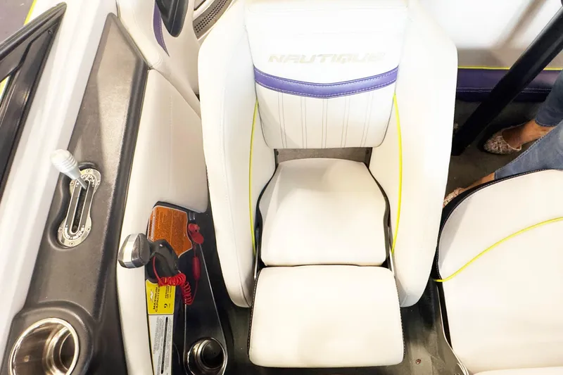 Slide: The Image of 2014 Nautique Ski Nautique 200 Closed Bow interior with white seating and control panel. - 15