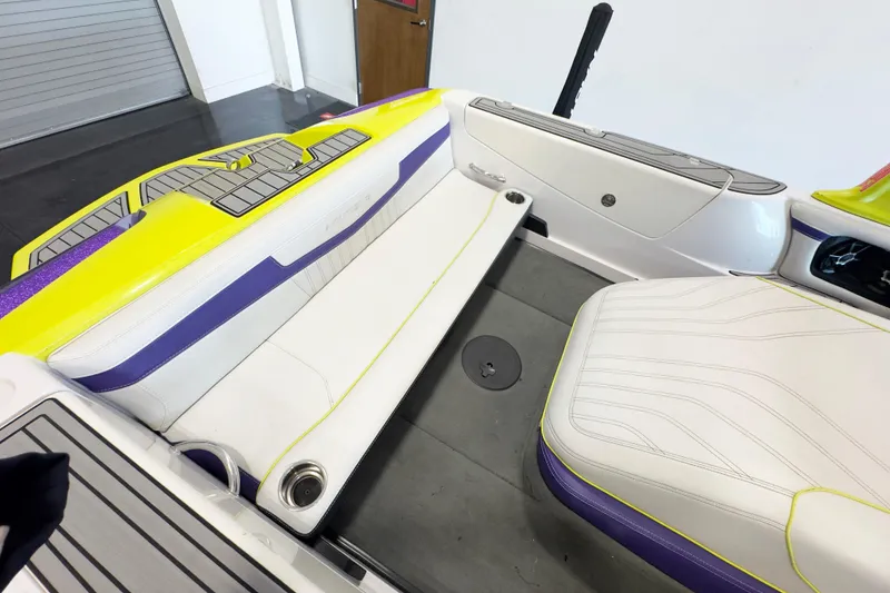 Slide: The Image of 2014 Nautique Ski Nautique 200 interior with white and purple seating, yellow accents. - 7