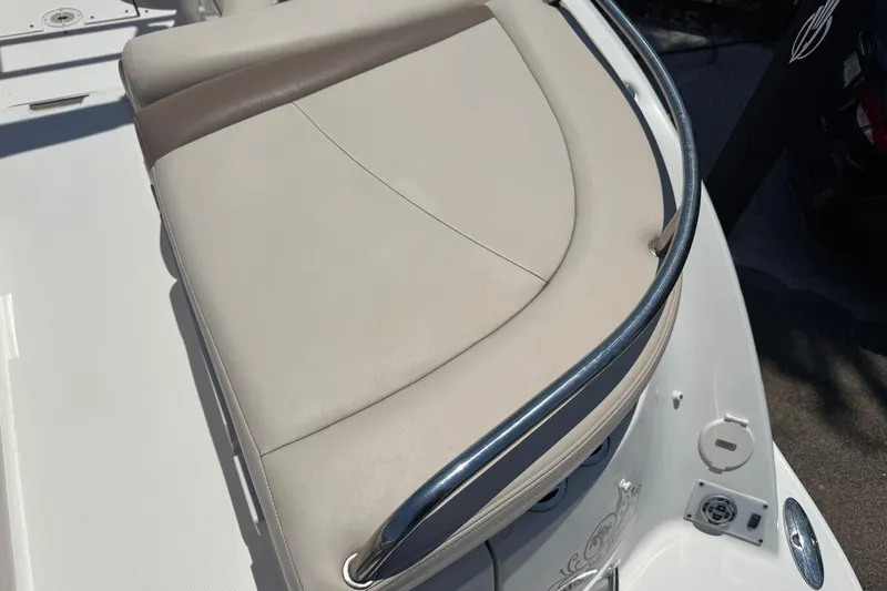 Slide: The Image of 2006 Chaparral 256 SSi boat seat with beige upholstery and metal railing. - 10