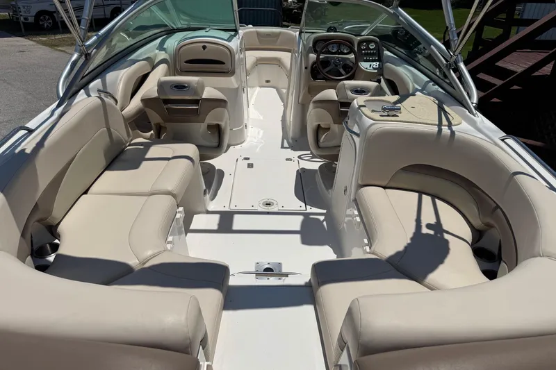 Slide: The Image of 2006 Chaparral 256 SSi boat interior with beige seating and modern dashboard. - 12