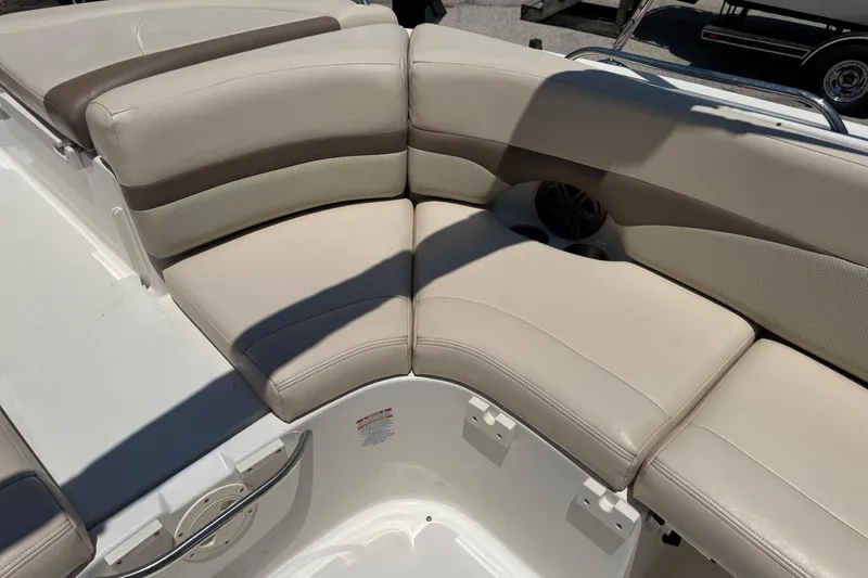Slide: The Image of 2006 Chaparral 256 SSi boat interior with beige cushioned seating. - 14