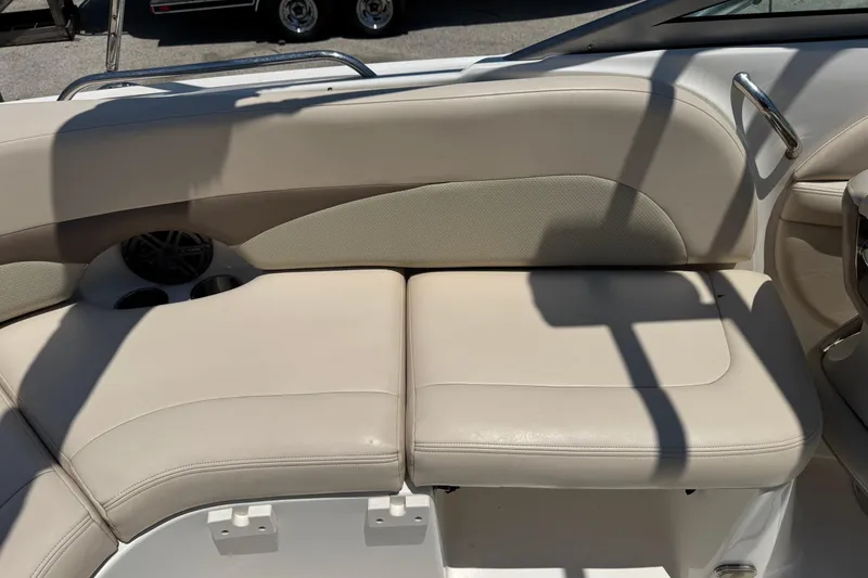 Slide: The Image of 2006 Chaparral 256 SSi boat interior with beige seating and cup holders. - 15