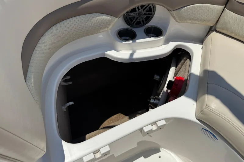 Slide: The Image of Storage compartment in 2006 Chaparral 256 SSi boat with cup holders and speaker. - 17