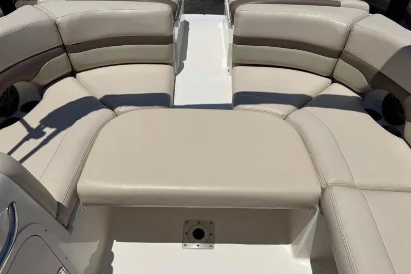 Slide: The Image of 2006 Chaparral 256 SSi boat interior with beige seating and spacious layout. - 19