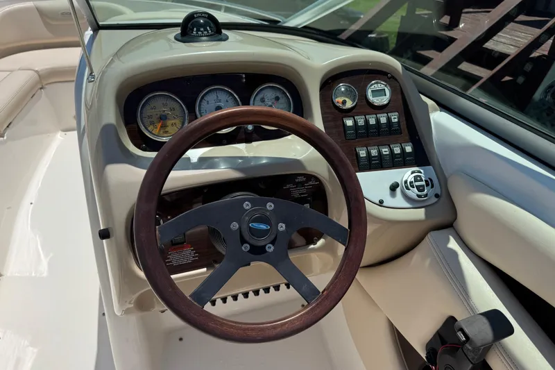 Slide: The Image of Steering wheel and dashboard of a 2006 Chaparral 256 SSi boat, featuring gauges and controls. - 20