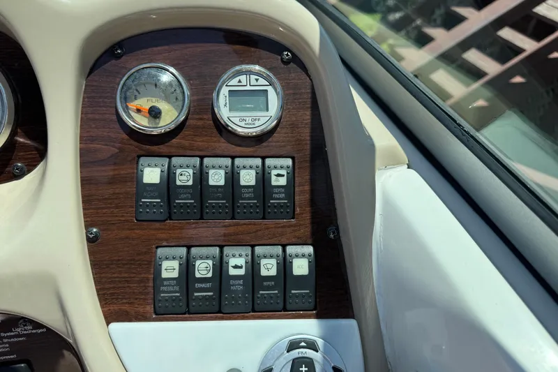 Slide: The Image of Dashboard controls of a 2006 Chaparral 256 SSi boat with fuel gauge and switches. - 21