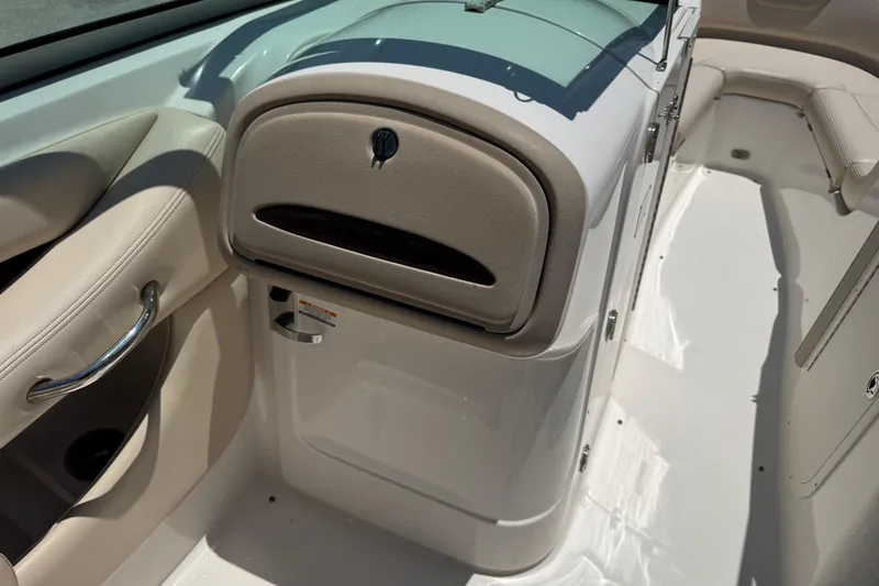 Slide: The Image of 2006 Chaparral 256 SSi boat interior with beige seating and storage compartment. - 23