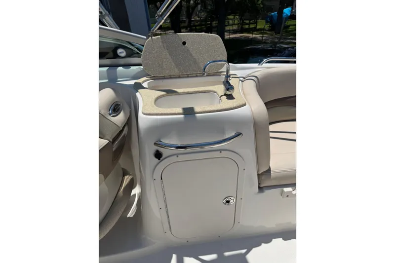 Slide: The Image of 2006 Chaparral 256 SSi boat interior with sink and storage compartment. - 25