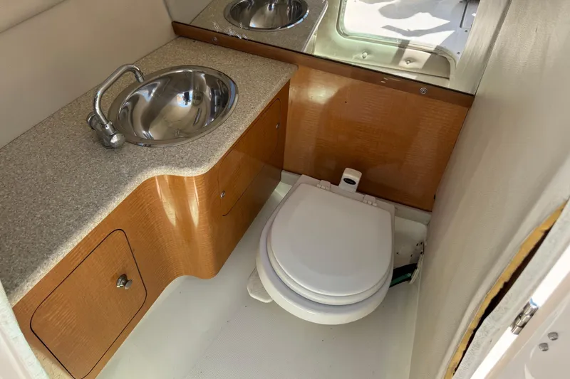 Slide: The Image of 2006 Chaparral 256 SSi boat bathroom with sink and toilet. - 26
