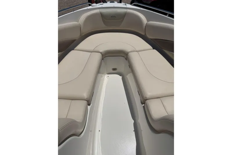 Slide: The Image of 2006 Chaparral 256 SSi boat interior with beige cushioned seating. - 29