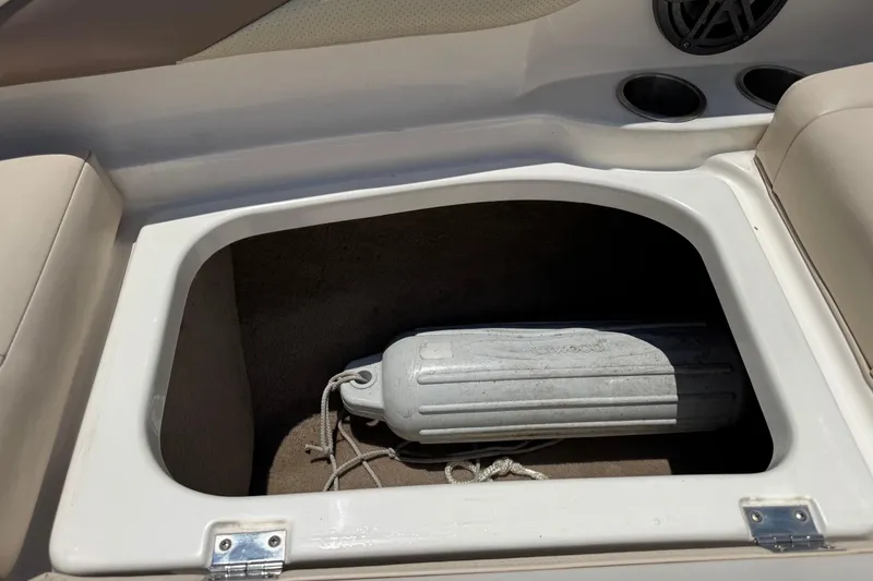 Slide: The Image of Storage compartment in a 2006 Chaparral 256 SSi boat with a fender inside. - 32