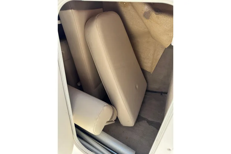 Slide: The Image of 2006 Chaparral 256 SSi boat interior with beige cushions and storage area. - 35