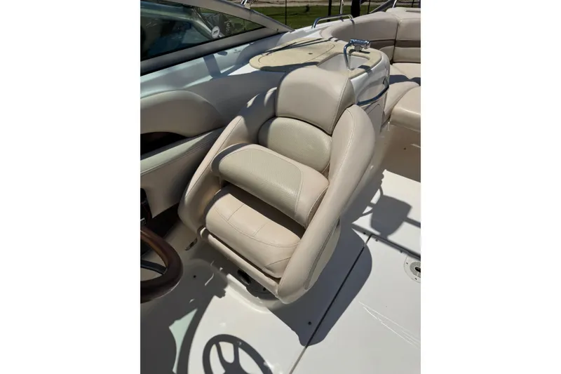 Slide: The Image of 2006 Chaparral 256 SSi boat interior with beige captain's seat and steering wheel. - 37
