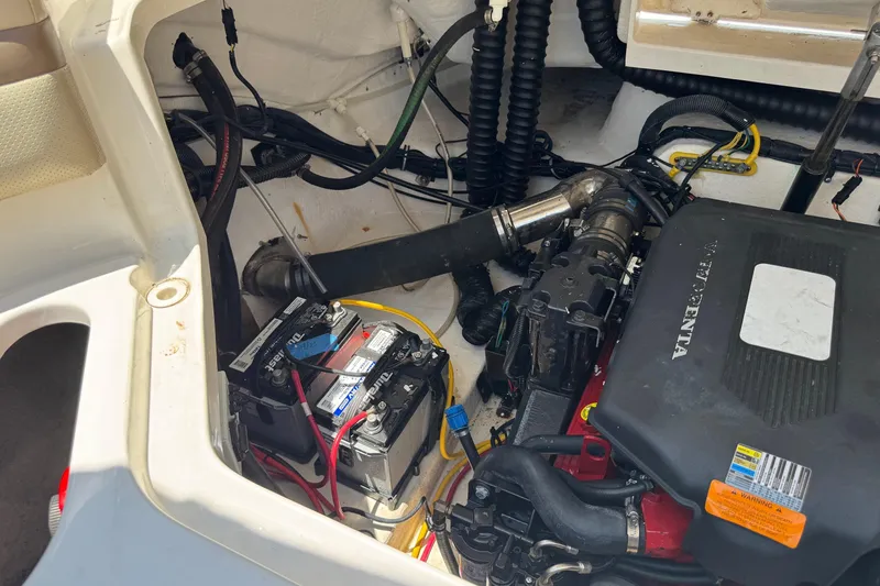 Slide: The Image of Engine compartment of a 2006 Chaparral 256 SSi boat, featuring batteries and wiring. - 39