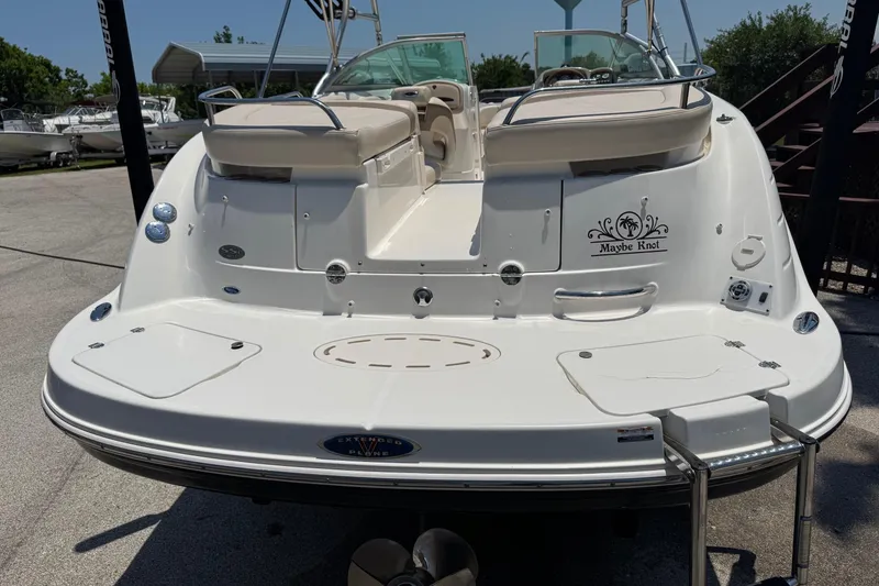 Slide: The Image of 2006 Chaparral 256 SSi boat with "Maybe Knot" decal, docked under clear skies. - 7