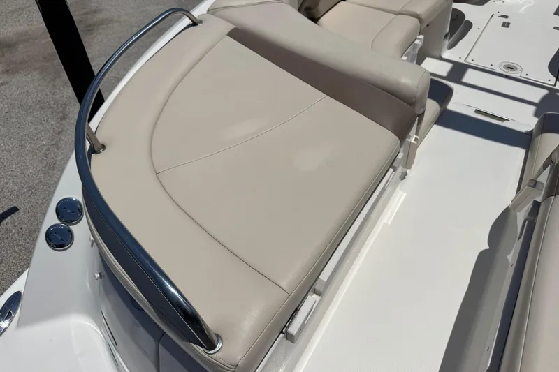 Slide: The Image of 2006 Chaparral 256 SSi boat interior with beige seating and stainless steel railing. - 8