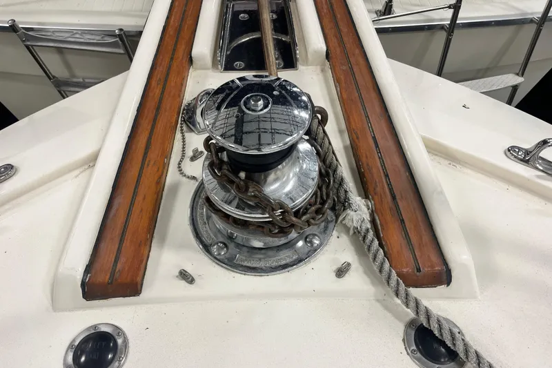 Slide: The Image of Anchor winch on 1991 Hatteras 40 Double Cabin yacht deck with wooden trim. - 10