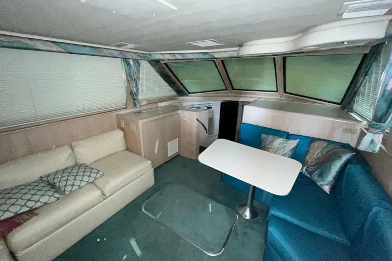 Slide: The Image of Interior of 1991 Hatteras 40 Double Cabin with cozy seating and table arrangement. - 16