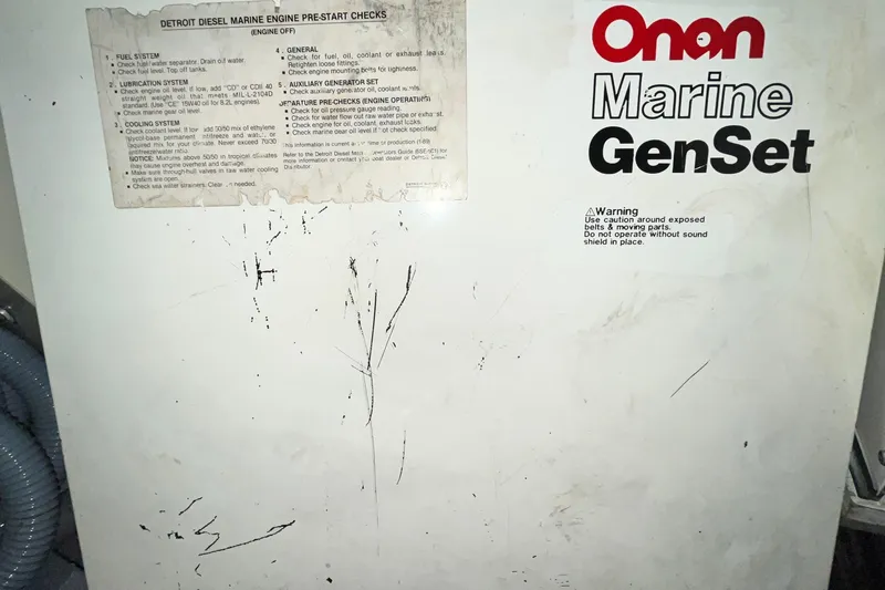 Slide: The Image of Onan Marine GenSet panel with pre-start checks for Detroit Diesel engine on 1991 Hatteras 40 Double Cabin. - 17