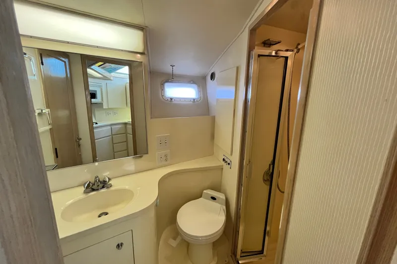 Slide: The Image of Bathroom interior of 1991 Hatteras 40 Double Cabin yacht with sink, toilet, and shower. - 16