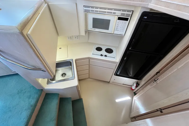Slide: The Image of Interior of 1991 Hatteras 40 Double Cabin kitchen with sink, stove, and microwave. - 14