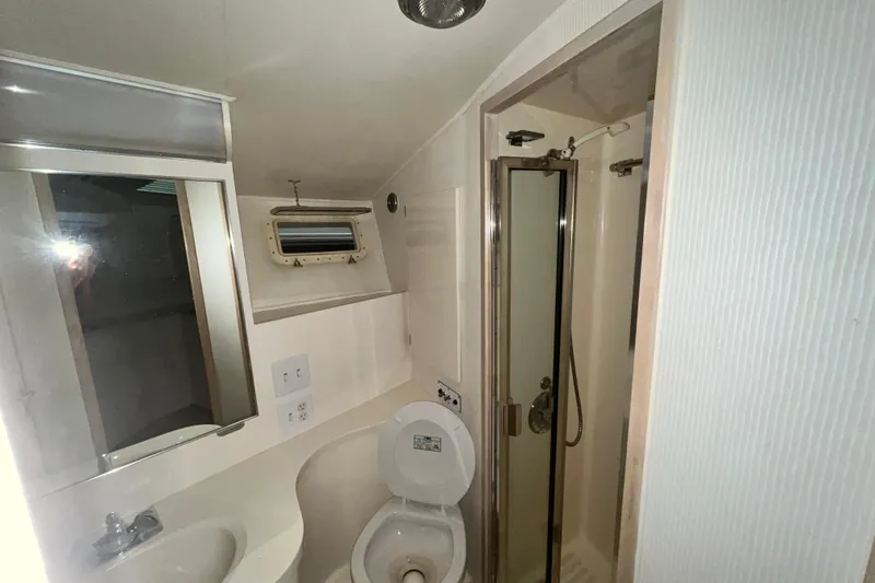 Slide: The Image of Bathroom interior of 1991 Hatteras 40 Double Cabin yacht, featuring shower and toilet. - 6
