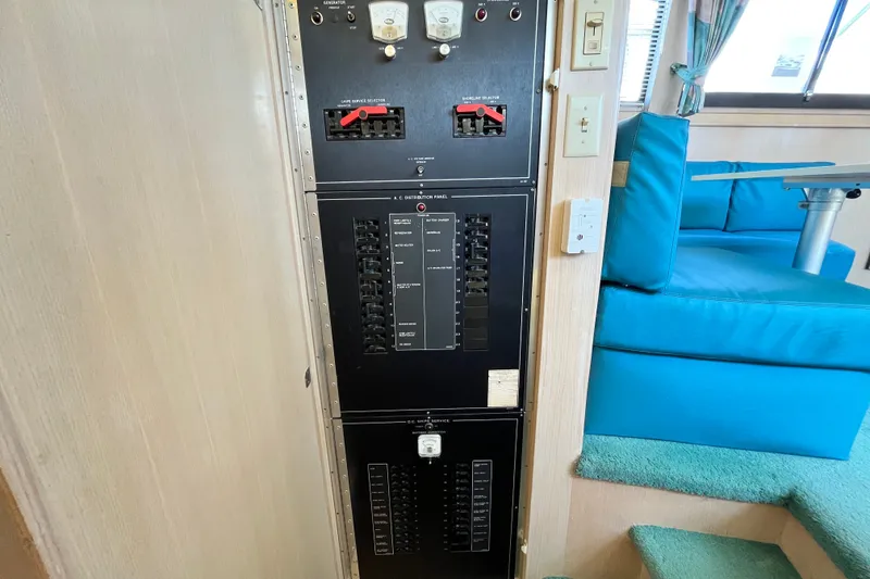 Slide: The Image of Electrical panel inside 1991 Hatteras 40 Double Cabin yacht, near blue seating area. - 15