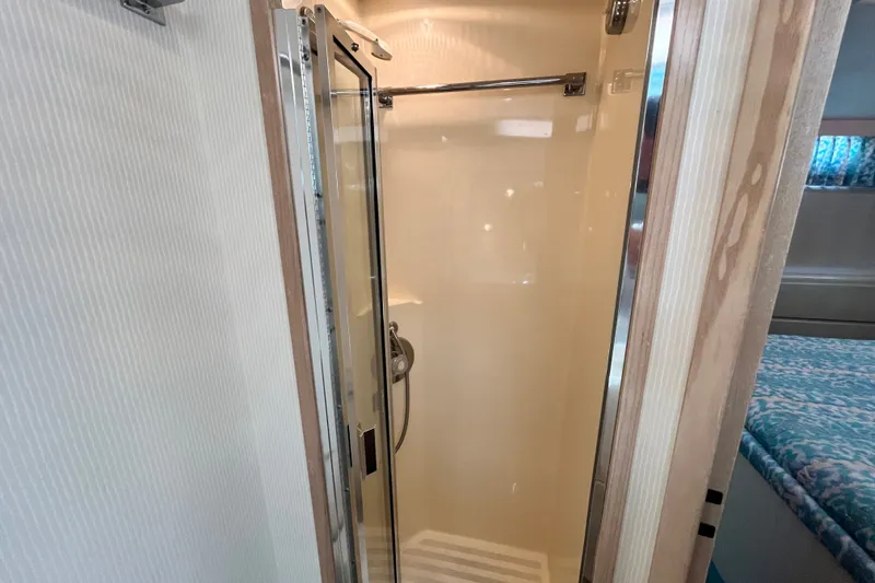 Slide: The Image of Shower area in 1991 Hatteras 40 Double Cabin yacht, featuring glass door and modern fixtures. - 21