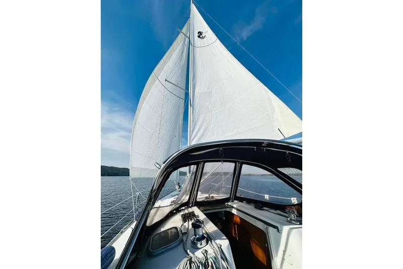Slide: The Image of 2007 Beneteau 343 sailboat with sails unfurled on a sunny day at sea. - 10