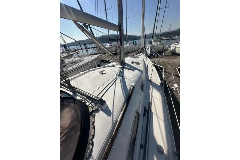 Slide: The Image of 2007 Beneteau 343 sailboat docked, showcasing deck and rigging under clear skies. - 11