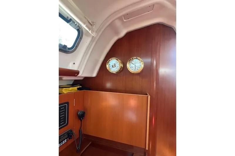 Slide: The Image of Interior of 2007 Beneteau 343 sailboat with wooden paneling and nautical instruments. - 14