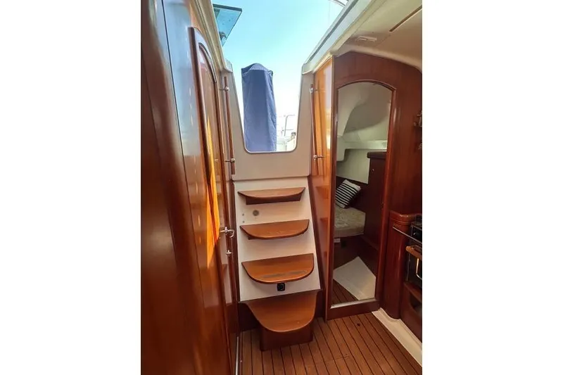 Slide: The Image of Interior of 2007 Beneteau 343 sailboat with wooden steps and cozy cabin. - 15