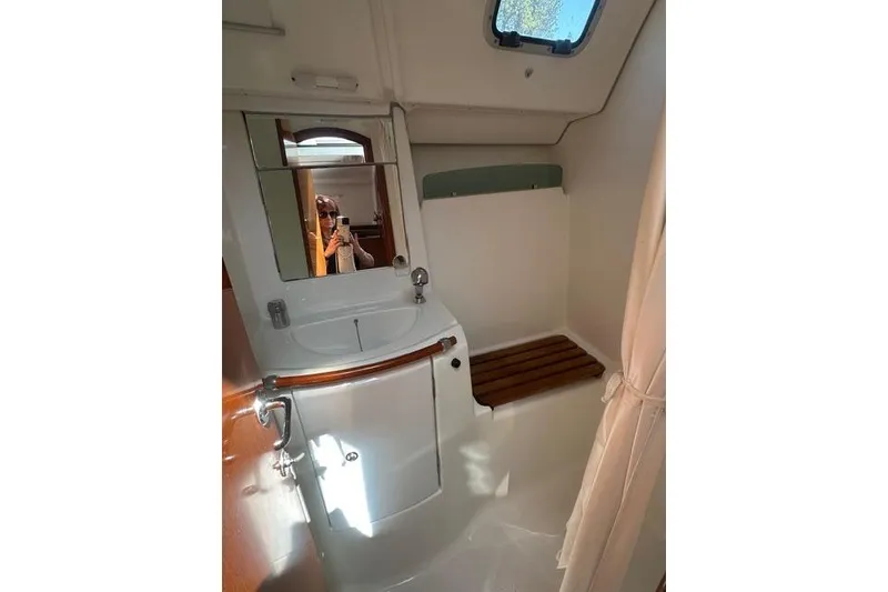 Slide: The Image of Bathroom interior of a 2007 Beneteau 343 sailboat with sink and mirror. - 16