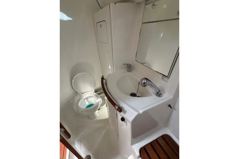 Slide: The Image of 2007 Beneteau 343 yacht bathroom with toilet, sink, and mirror. - 18