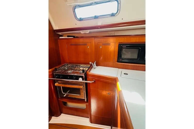 Slide: The Image of Interior of 2007 Beneteau 343 yacht kitchen with stove, sink, and microwave. - 20