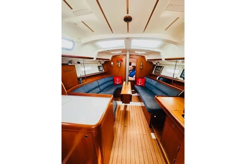 Slide: The Image of Interior of 2007 Beneteau 343 sailboat with wooden finish and blue seating. - 21