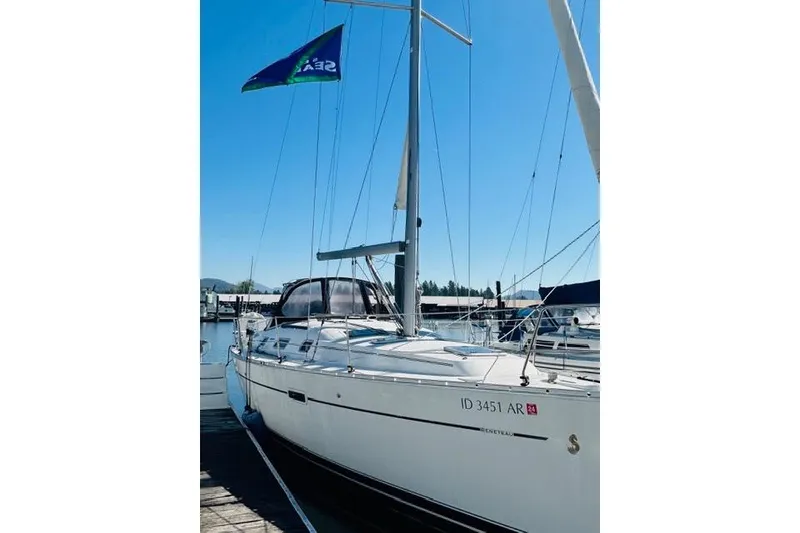 Slide: The Image of 2007 Beneteau 343 sailboat docked, featuring sleek design and vibrant flag. - 5