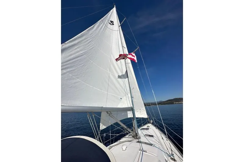 Slide: The Image of Sailing on a 2007 Beneteau 343 yacht with white sails against a clear blue sky. - 6
