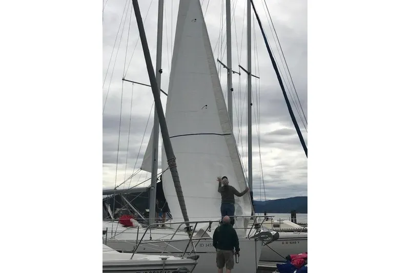 Slide: The Image of 2007 Beneteau 343 sailboat with raised sails at a marina, cloudy sky backdrop. - 7