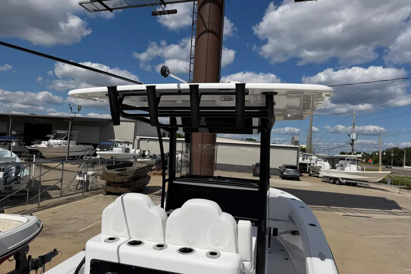 Slide: The Image of 2026 Bluewater Sportfishing 25T boat with T-top, parked in a marina under a blue sky. - 11