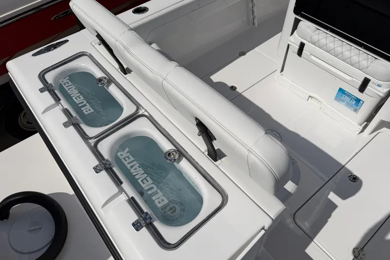 Slide: The Image of 2026 Bluewater Sportfishing 25T boat interior with dual livewells and cooler. - 12