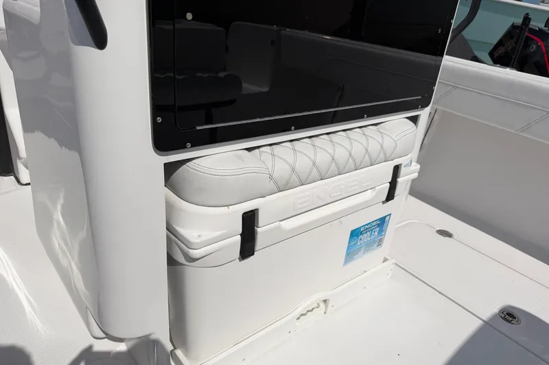 Slide: The Image of 2026 Bluewater Sportfishing 25T boat interior with Engel cooler and cushioned seating. - 14
